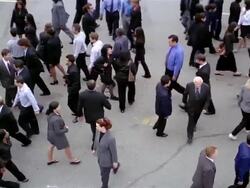 Slow motion high angle wide shot overhead shot of crowd of businesspeople walking back and forth Stock Footage