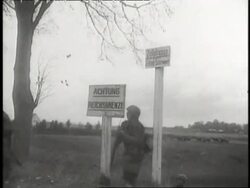 Russian soldiers knock over a German sign. News Clip