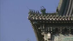 A dragon statue decorates the roof of a temple in Beijing. Stock Footage