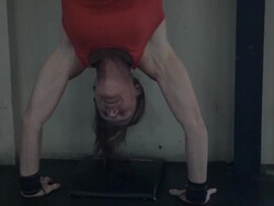 Close-up. Jean Anne performs series of handstand push-ups. Stock Footage