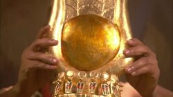 A pair of hands places a gold crown with wings on the head of cleopatra. Stock Footage
