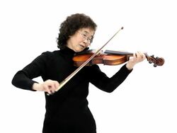 Elderly woman playing violin Stock Footage