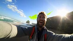 Young man takes a selfie portrait on Gibsons steps beach Stock Footage