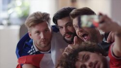 Guys sitting on couch taking selfies Stock Footage