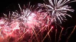 Beautiful colors erupt as fireworks explode against a night sky. Stock Footage