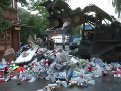 Medium Shot - Garbage truck pushing trash into a large pile / New Orleans Louisiana Stock Footage
