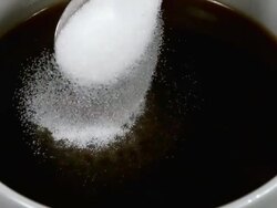 CU SLO MO Sugar being poured into bowl of Coffee / Vieux Pont, Normandy, France Stock Footage