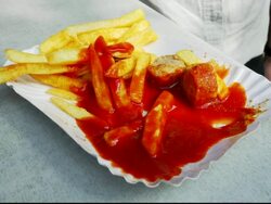 CU Average Woman Eating Currywurst And French Fries At Fast Food Stand In Berlin Stock Footage