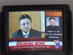 People watching Musharraf resignation on TV News Clip