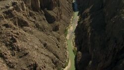 The Rio Grande flows between steep limestone cliffs in Mariscal Canyon, one of several canyons in Big Bend National Park, Texas. Stock Footage