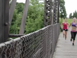 MS Two young girls running on bridge and taking rest / Minneapolis, Minnesota, United States Stock Footage