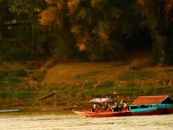 MS TS Shot of wooden boat moving on mekong river / Luang Prabang, Laos Stock Footage