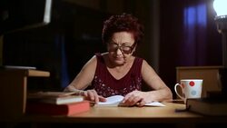 Grandmother reading a book Stock Footage
