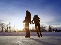 Young adult couple skating together on ice. Stock Footage