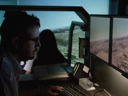 WS PAN instructor and student pilots in helicopter flight simulator during simulated flight over mountainous terrain; focus remains on instructor throughout, RED R3D 4K Stock Footage