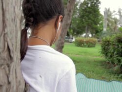 Girl listen to music from Smart Phone,Dolly shot Stock Footage