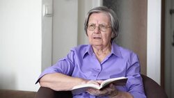 Grandmother reading a book Stock Footage
