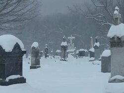 MS View of Snowy cemetery in blizzard in winter evening  / Ellicottville, New York, Canada  Stock Footage