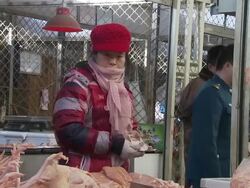 Shoppers and butchers at a Beijing meat market News Clip