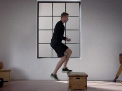 Man doing his workout in gym (hydraulic jump with box) Stock Footage