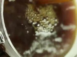 Cream splashing into coffee cup Stock Footage