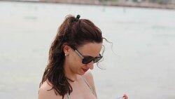 Cheerful sexy brinete in bikini taking a self picture Stock Footage