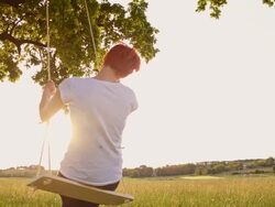 SLO MO Young woman swinging on a tree swing Stock Footage