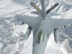 MS F-16 fighter jet flying away after mid-air refueling, Colorado Rockies, Colorado, USA Stock Footage