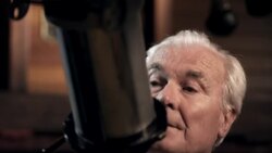 Old man with telescope Stock Footage