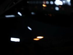 MS TU Well dressed young man getting into drivers seat of his modern convertible car at night in urban area / Minneapolis, Minnesota, United States Stock Footage