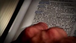 A finger points to a word in a french dictionary and then to a word in an english-french dictionary. Stock Footage