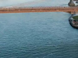 Aerial of Brooklyn bridge flying up the East river in the late afternoon, NYC Stock Footage
