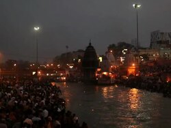 Pilgrims at riverbank at night, Ganges River, Haridwar, Uttarakhand, India Stock Footage