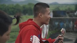 M/S group of Burmese teenagers playing music in the flat roof of an abandoned building Stock Footage
