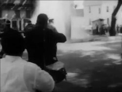 B/W 1963 PAN firemen hosing demonstrators on street in civil rights protest / Alabama / newsreel Stock Footage