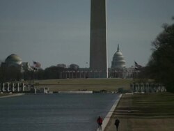 Medium Long Shot pan-left - A cloudy sky outlines the United States Capitol dome behind the Washington Monument. / Washington, D.C., USA Stock Footage