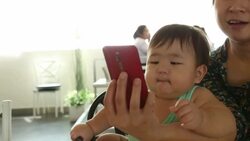 Mam and Baby using smart phone conference call Stock Footage