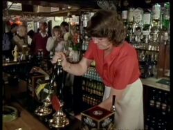 Woman draws pint in pub, Kent, UK  1984 Stock Footage
