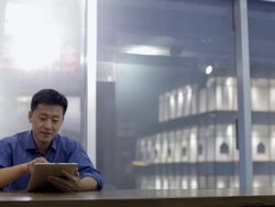 MS ZI Young man using digital tablet in modern office / China Stock Footage