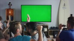 Guys sitting on couch watching tv and cheering Stock Footage