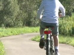 WS Girl with bicycle / Kastel-Staadt, Rhineland-Palatinate, Germany   Stock Footage