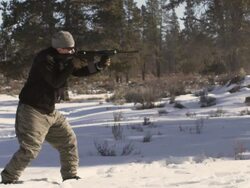 MS SLO MO Shot of man shoots an AR-15 rifle in winter wood landscape / Bend, Oregon, United States  Stock Footage