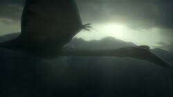 Pterodactyls fly high above a rugged, mountainous landscape. Stock Footage