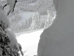 A male skier does a backflip off of a small jump in the backcountry Stock Footage