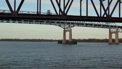 Aerial flying under truss bridge and Betsy Ross Bridge on Delaware River Stock Footage