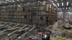 Staff working in a busy Amazon warehouse on Black Friday News Clip