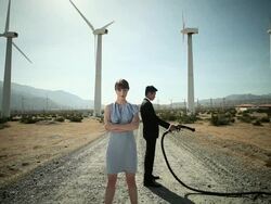 Woman and man at wind farm with gas pump Stock Footage