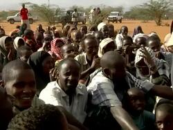 Refugees sitting on ground Stock Footage