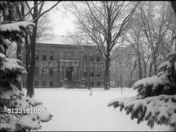 1952: CHRISTMAS IN ELKHORN: VS Snow covered park & streets of Elkhorn, pedestrians, buildings, trees, courthouse building. VS High school students decorating stage w/ Christmas decorations (Nativity scene), Santa Claus ornament. WI, holidays, Winter Instructional Video