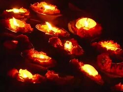 CU burning oil lamps at ghat in Ganges River / Varanasi, Uttar Pradesh, India Stock Footage